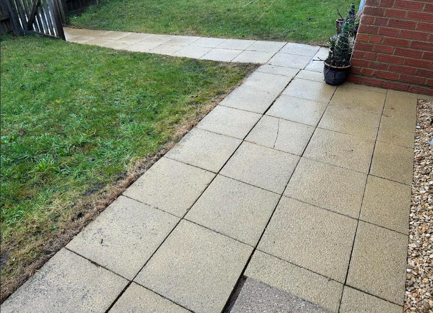 picture showing part of jet washed patio and some grass