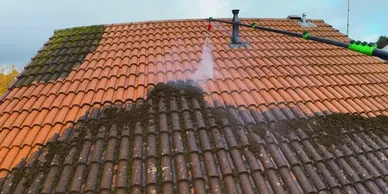 tiled roof showing parts of it that have been cleaned and parts which are being cleaned  - roof cleaning 