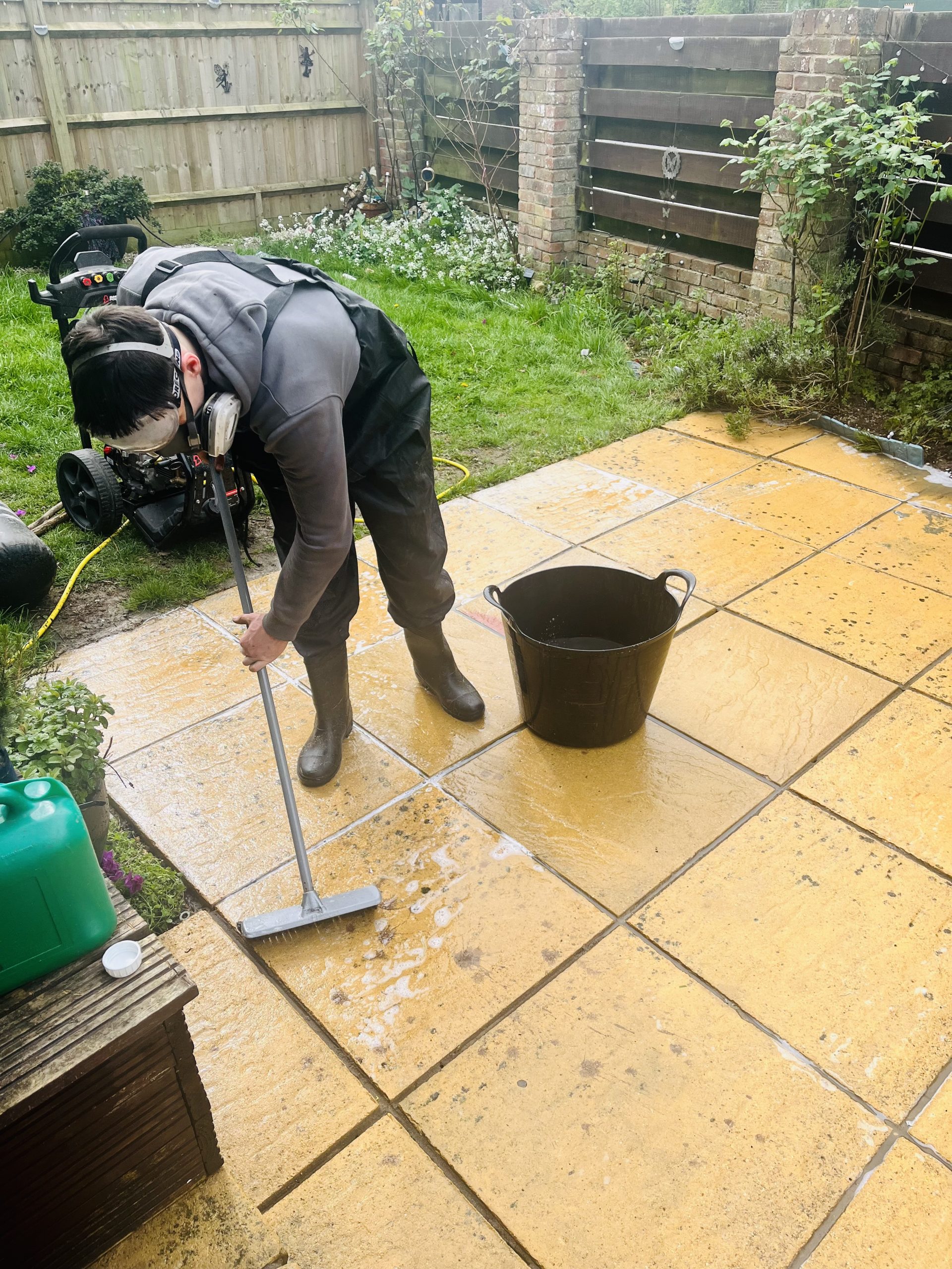 James cleaning patio with chemicals