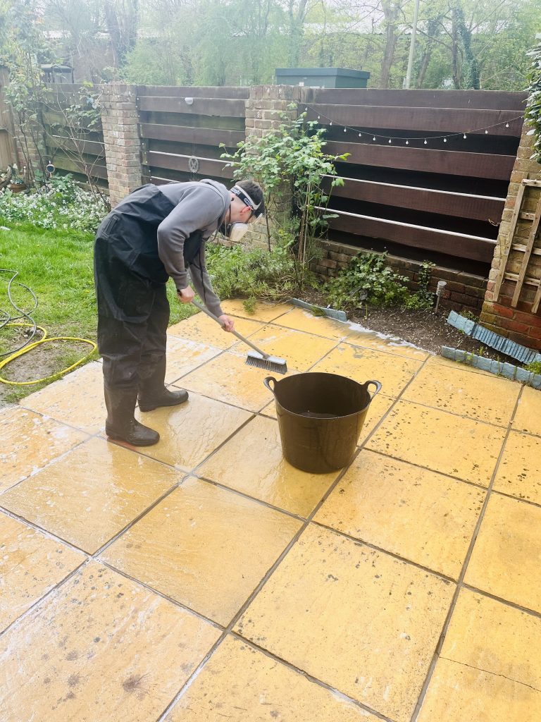 James cleaning patio with chemicals