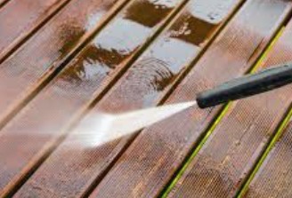 part of wood decking being jet washed 