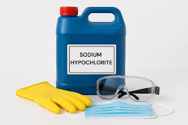 Bottle of chemicla with yellor rubber glove and protective galsses 